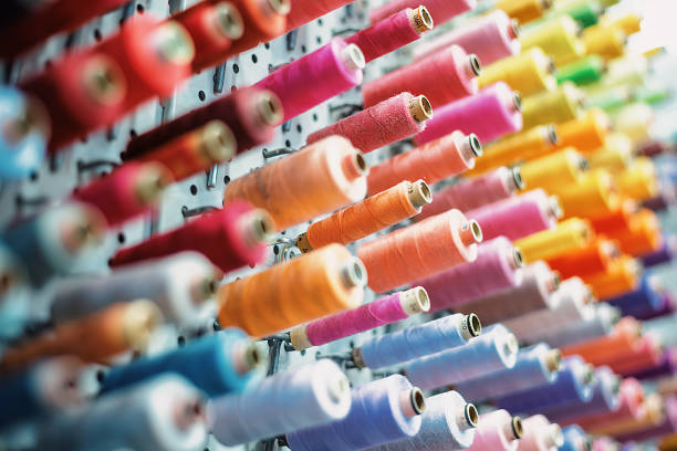 istock Colorful thread spools hanging on a wall, ready for sewing and tailoring 2192115893