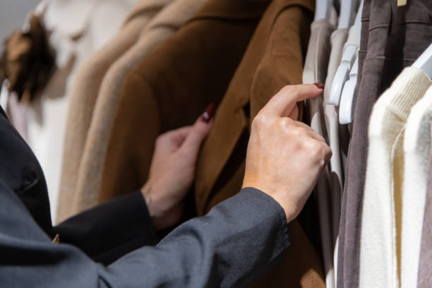 Female hands holding brown coat