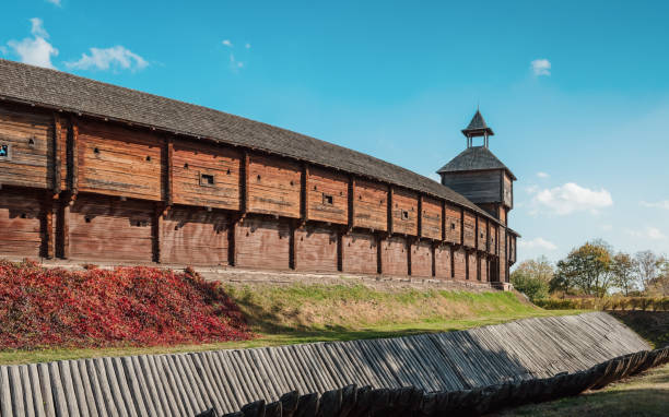 Baturyn Fortress Citadel on a sunny autumn day. Long wooden wall and tower of wooden castle with defensive moat and fortified slopes. Baturyn, Ukraine - October 14 2020. baturyn stock pictures, royalty-free photos & images