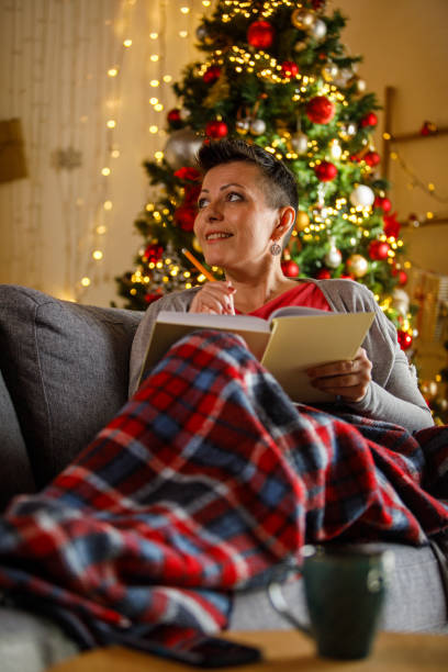 istock Woman Relaxing While Writing Her Journal During the Holiday Season 2192120728