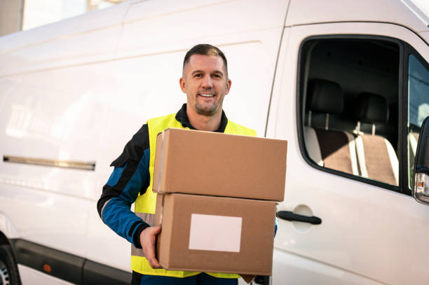 istock Delivery person holding packages 2192121374