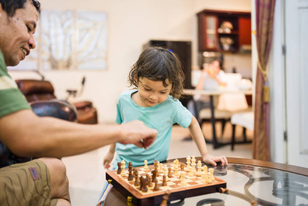 istock Grandfather and grandson playing chess together 2192122704