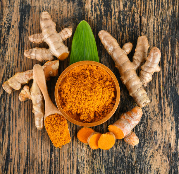 istock Top view Turmeric roots with turmeric powder on wooden background 2192126929