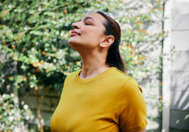 istock Woman Taking a Deep Breath Outdoors in Fresh Air 2192131701