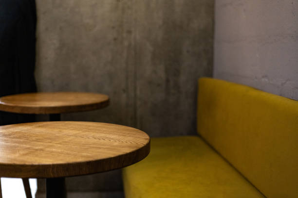 a mustard-colored sofa near the tables in the cafe