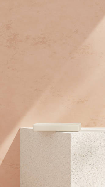 istock Empty mockup featuring a ceramic textured podium against a simple pink wall in a portrait layout 2192133743