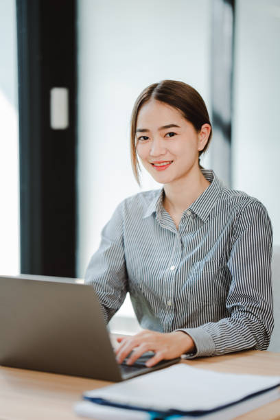 istock Asian businesswoman working at office using laptop and documents on table Plan to analyze financial reports investment business plan financial analysis concepts 2192134464