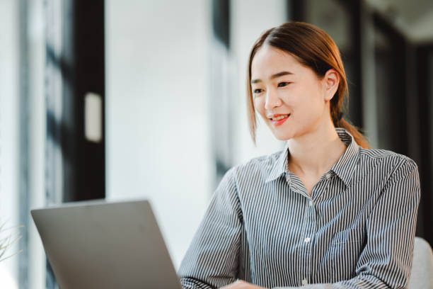 istock Asian businesswoman working at office using laptop and documents on table Plan to analyze financial reports investment business plan financial analysis concepts 2192134480