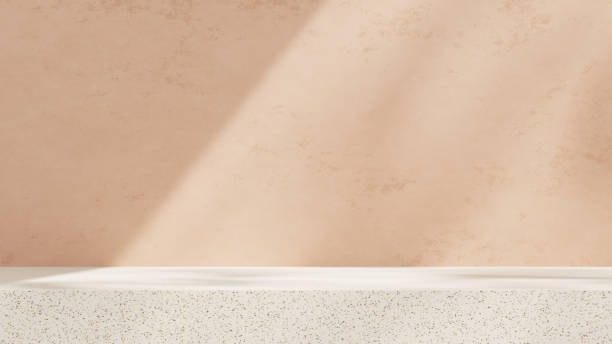 istock Empty mockup featuring a ceramic textured podium against a simple pink wall in a landscape layout 2192137128