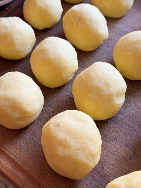 Homemade German potato dumplings prepared in rustic Bavarian kitchen for Christmas celebration dinner