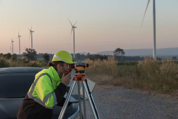 istock Survey Team Alternative energy for future. Engineers survey and checking wind turbines in sunset. Wind Turbine Renewable energy technology and sustainability. 2192138607