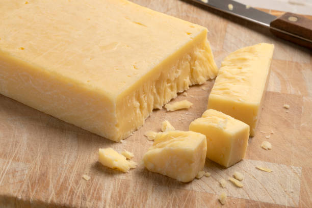 istock Extra mature english traditional cheddar cheese and pieces on a cutting board 2192142565