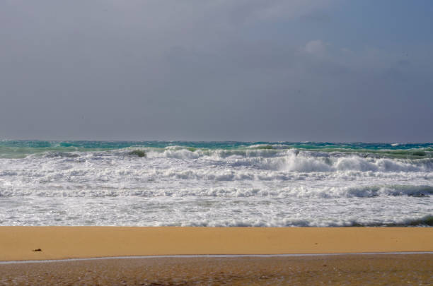 Discover the soothing charm of soft waves lapping a sandy beach. A close up view of nature s calm for ultimate relaxation and coastal inspiration