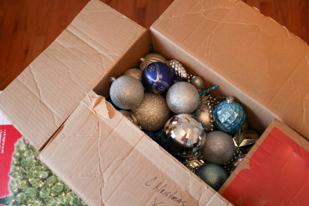 a cardboard box of Christmas ornaments