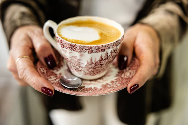 istock Woman holding a vintage coffee cup with frothy coffee. 2192146973