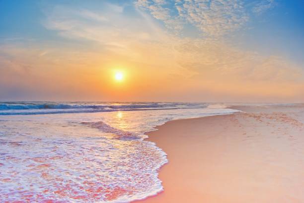 istock Colorful sunset viewed from the pink sea beach with soft waves 2192147285