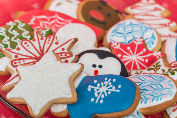 A beautiful selection of traditionally decorated, homemade gingerbread cookies for Christmas served on a glass bowl