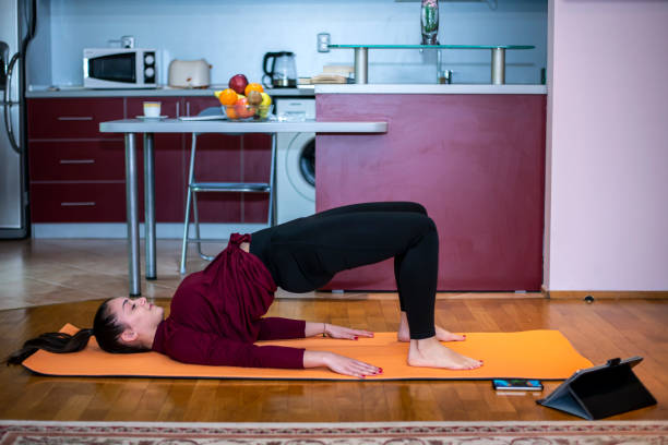 istock Woman practicing yoga at home 2192155066
