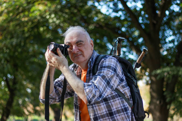 istock Senior man hiking and shooting photos 2192157502