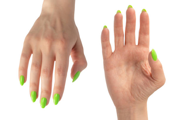 istock Hand of a woman with green naols hold some tiny or thin object. 2192158658