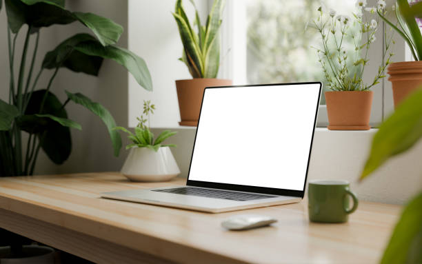 istock Laptop with a blank screen, placed on a wooden desk in a bright, modern interior. CGI render 2192159320
