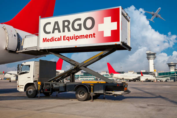 Airport highloader truck loading medical equipment cargo into an airplane