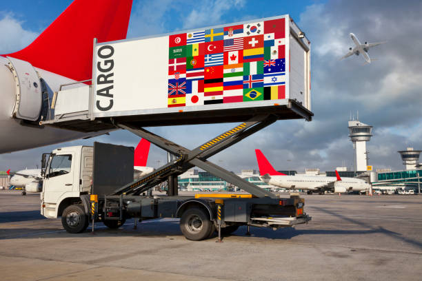 istock Airport high loader lifting cargo container with international flags near airplane 2192160674