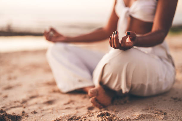 istock Person practicing meditation on a sandy beach during a peaceful sunset 2192162856