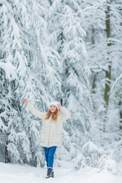 istock Beautiful young woman in snowy forest. 2192163587