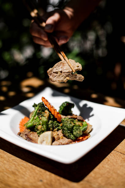istock Authentic Thai stir-fried broccoli with beef, wok-fried vegetables with tender beef slices, flavorful and healthy Thai cuisine, served in an elegant white dish, traditional Asian dining experience 2192164236