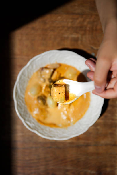 istock Authentic Thai Massaman curry, rich and creamy coconut-based curry with potatoes and beef, traditional slow-cooked Thai dish, mild and aromatic flavors, served in an elegant ceramic bowl, gourmet Thai cuisine experience 2192164404