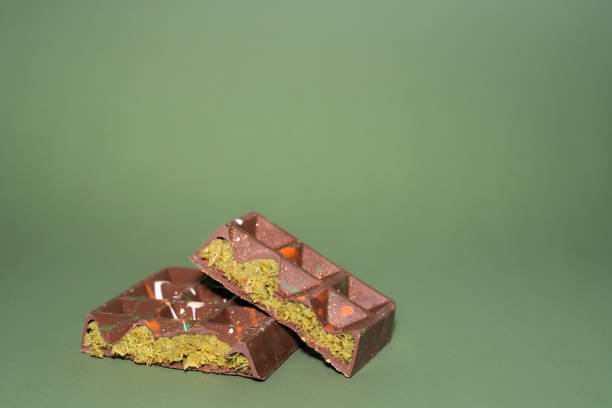 istock Trend Dubai chocolate bar with pistachio paste, tahini and kataifi dough on green background. Confectionery and sweets. 2192167548