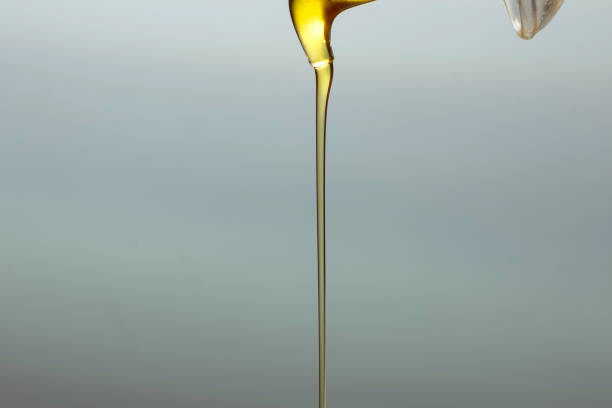 istock Detail of virgin olive oil falling from a bottle. The image allows copyspace 2192170006
