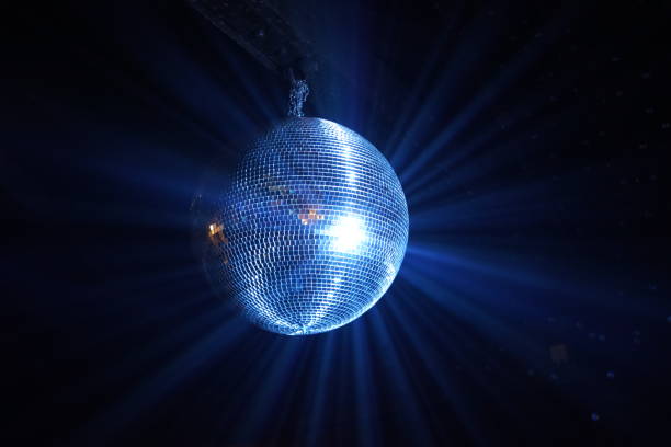 istock A Disco ball is a mirrored ball suspended from the ceiling in a dark room, which slowly rotates and is illuminated to produce a 