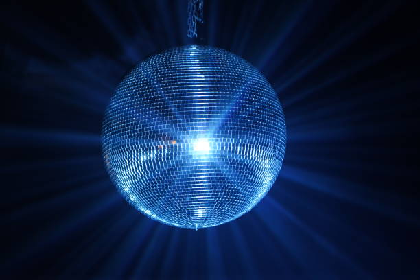 istock A Disco ball is a mirrored ball suspended from the ceiling in a dark room, which slowly rotates and is illuminated to produce a 
