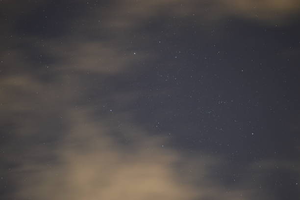 istock Evening clouds in the sky with the constellation Taurus and others around it. 2192174674
