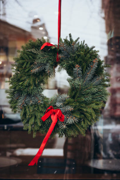 istock Handmade Christmas wreath hangs in cafe window. Festive winter decorations. 2192175428