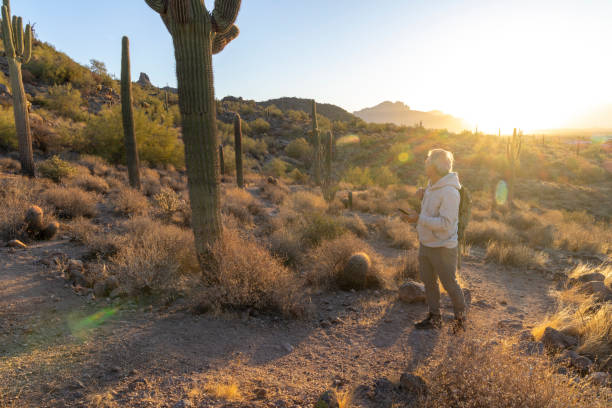 istock Mature man uses mobile phone on desert trail 2192175718