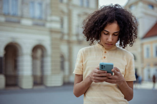istock Teenage Boy Browsing on His Smartphone 2192177717