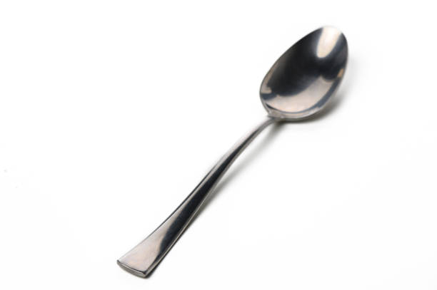 istock Elegant stainless steel spoon resting on a white surface with a subtle shine captured in soft light 2192178757