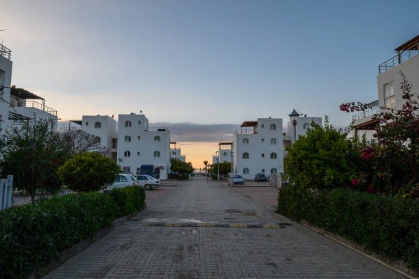 istock Tranquil sunset at a coastal resort with white buildings and lush greenery 2192178775