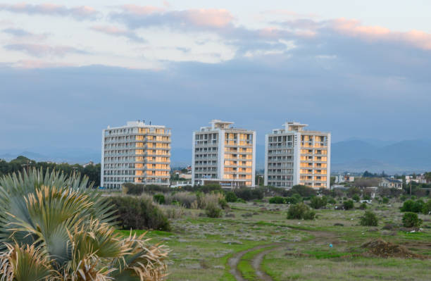 Modern buildings shine under a soft evening sky in a tranquil coastal environment