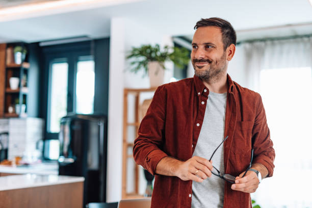 istock Happy entrepreneur working from home looking away and smiling 2192181541