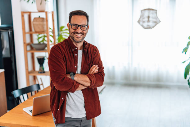 istock Confident entrepreneur smiling with arms crossed in his home office 2192181542
