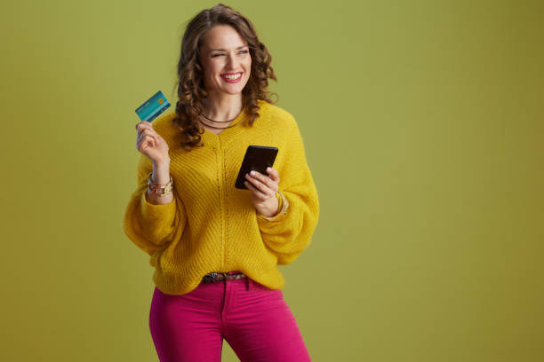 istock smiling healthy woman using smartphone isolated on green 2192182714