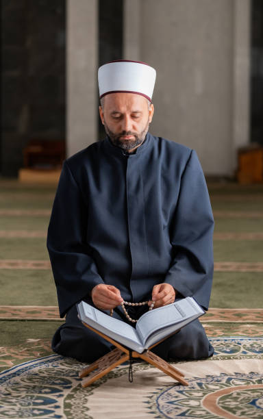 istock A Muslim prayer man praying while reading a Quran inside the mosque. 2192185216