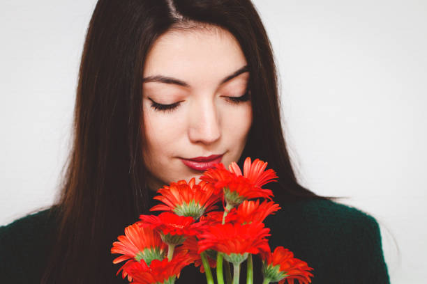 istock Portrait of a beautiful brunette with gerberas. 2192185250