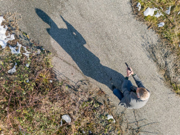 Shadow of a detective with hand gun