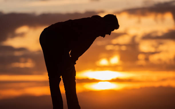 Silhouette of muslim woman prayer having worship and praying with hands open doing dua to Allah at sunset . High quality photo