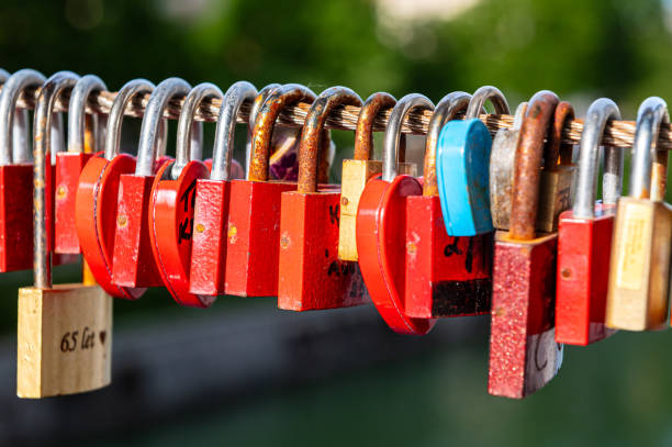 istock Padlocks aligned on a metal wire, almost all red 2192187899